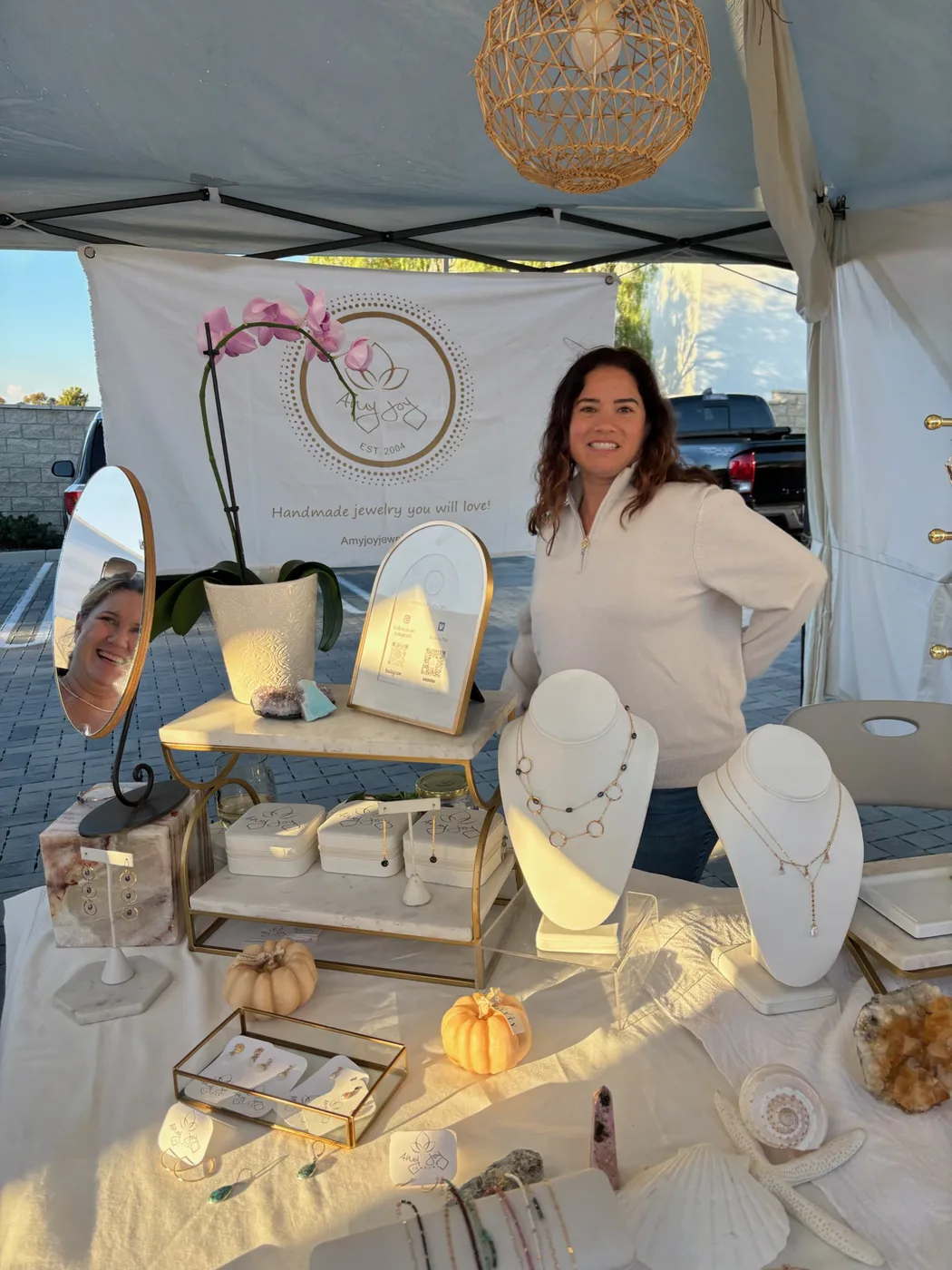 A jewelry vendor sharing her creations at the market